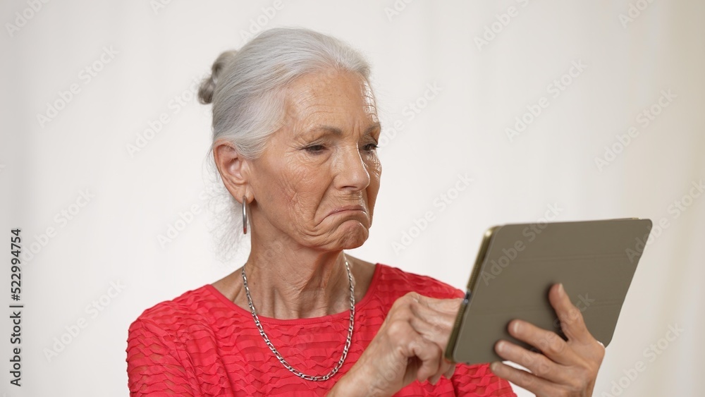 Portrait of mature elderly woman posing holding phone video chat isolated on solid white background. Portrait of mature elderly woman posing holding phone video chat isolated on solid white background.