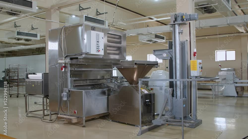 Big dough machine for mixing, cutting and rolling dough in the middle of bakery Big dough machine for mixing, cutting and rolling dough in the middle of bakery