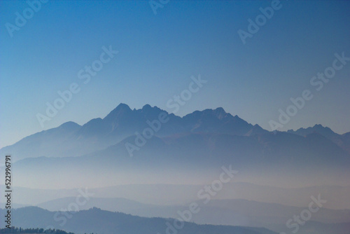 Silhouette of High Tatras Mountains at sunrise at clear blue sky background