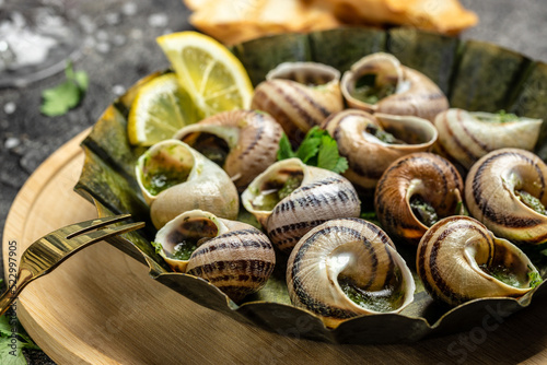 Snails baked with sauce, Bourgogne Escargot Snails. Baked snails with butter and spice. gourmet food. recipe background. Close up photo