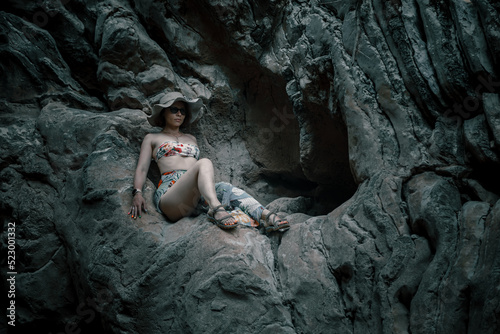 Beautiful girl on the rocks in the canyon. Dry bed of a former river. Girl in swimsuit. Small beautiful canyon.