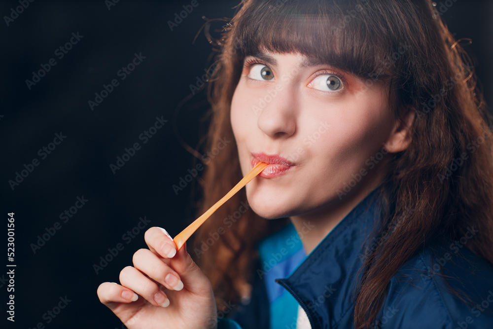 Obraz premium Young girl 80 and 90's style. 90s fashion positive girl chewing bubble gum
