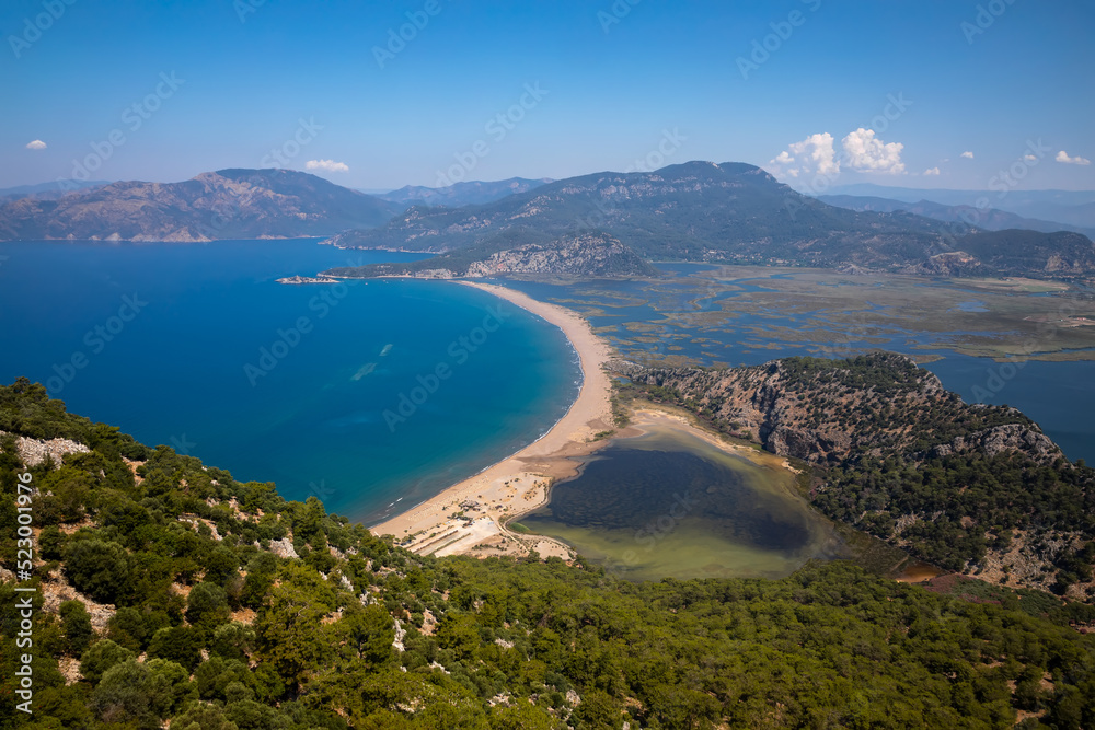 Obraz premium Beautiful seashore. Islands in the distance. Colorful blue sea. The beauty of Turkey. Beautiful rocks and mountains. Sunny clear day. Beautiful water.