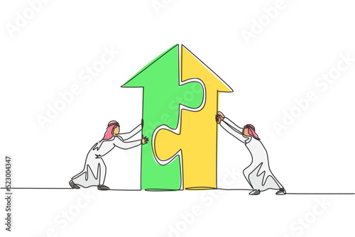 Continuous one line drawing two young handsome Arabian male workers pushing puzzle pieces to build a building. Business teamwork minimalist concept. Single line draw design vector graphic illustration
