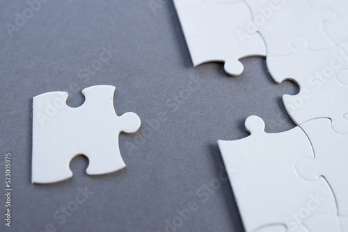 Empty white jigsaw puzzle with missing pieces