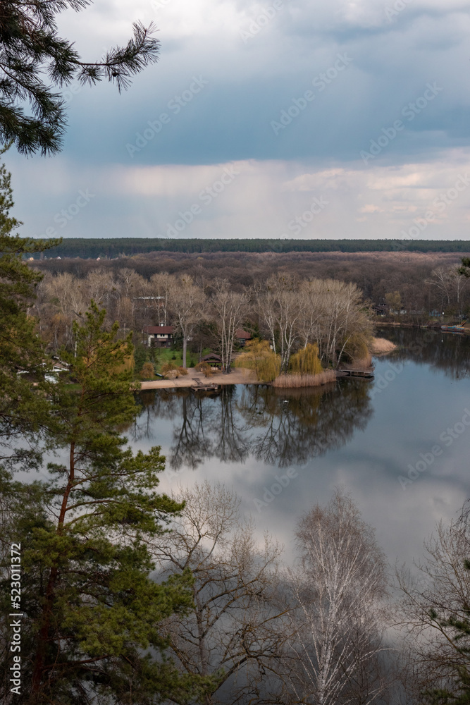 Obraz premium Spring rainy clouds on river bank recreation area. Cossack mountain (Gomilshanski forest, Koropove village) on Siverskyi Donets River in Ukraine