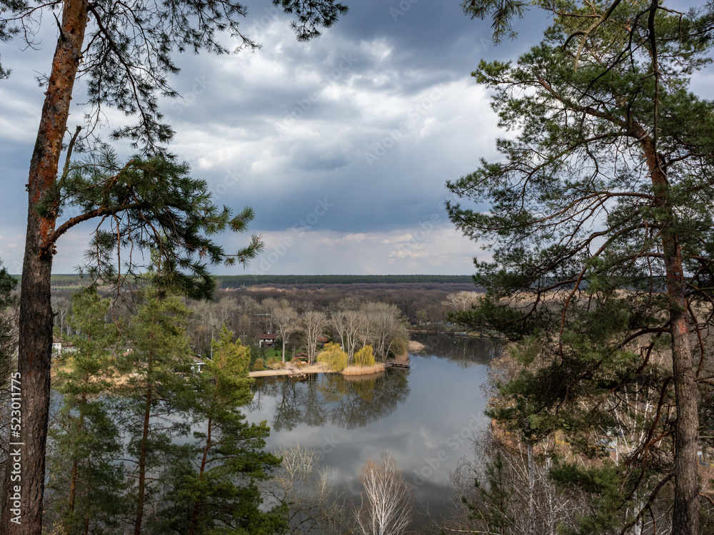 Scenic river bank with pine trees and epic cloudscape. Cossack mountain, Korobovy Hutora (Gomilshanski forest, Koropove village) on Siverskyi Donets River in Ukraine Scenic river bank with pine trees and epic cloudscape. Cossack mountain, Korobovy Hutora (Gomilshanski forest, Koropove village) on Siverskyi Donets River in Ukraine