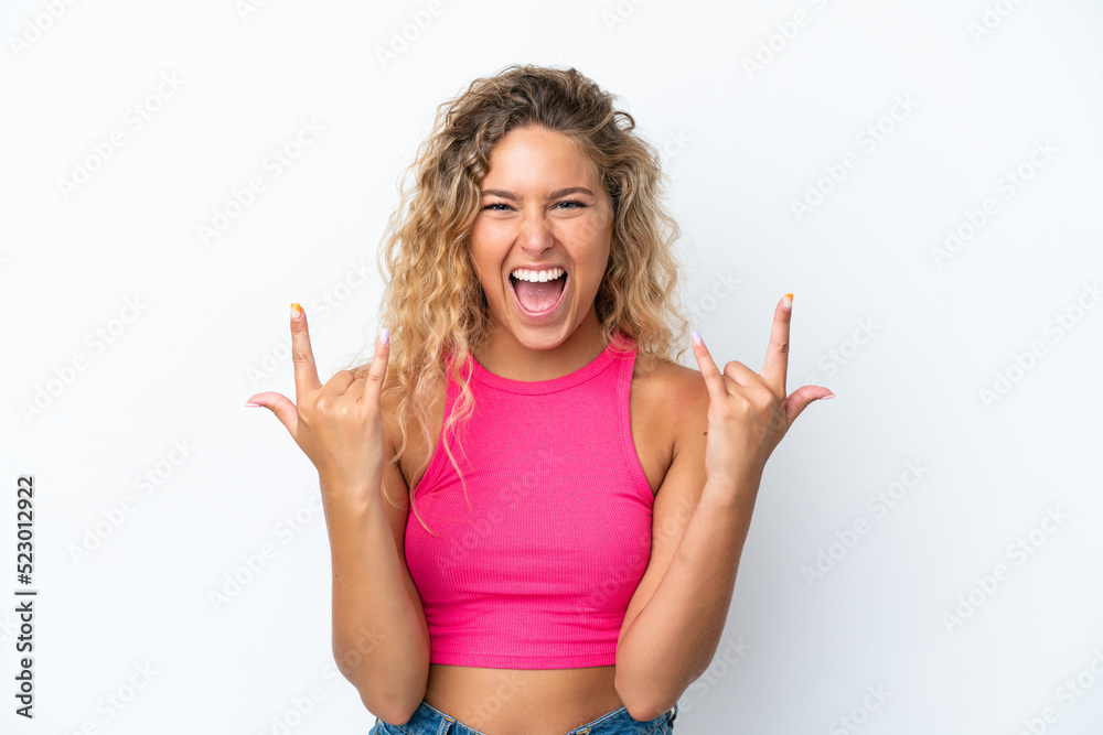 Fototapeta premium Girl with curly hair isolated on white background making horn gesture
