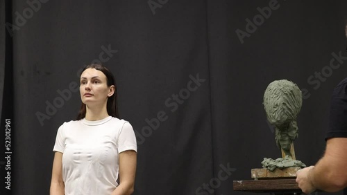 Man sculptor creates sculpt bust clay human woman sculpture. Statue craft creation workshop. Small business.