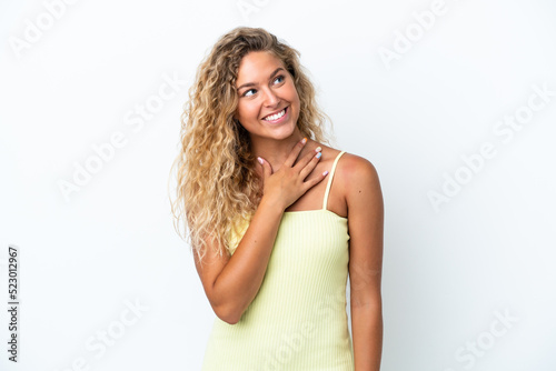 Girl with curly hair isolated on white background looking up while smiling