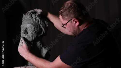 Man sculptor creates sculpt bust clay human woman sculpture. Statue craft creation workshop.