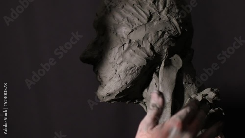 Man sculptor creates sculpt bust clay human woman sculpture. Statue craft creation workshop.