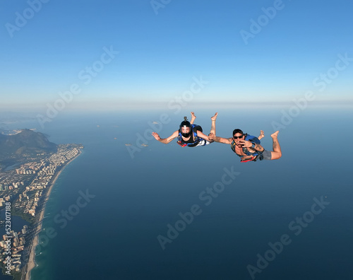 Skydiving in the Rio de Janeiro. A summer day, shirtless on the beach.