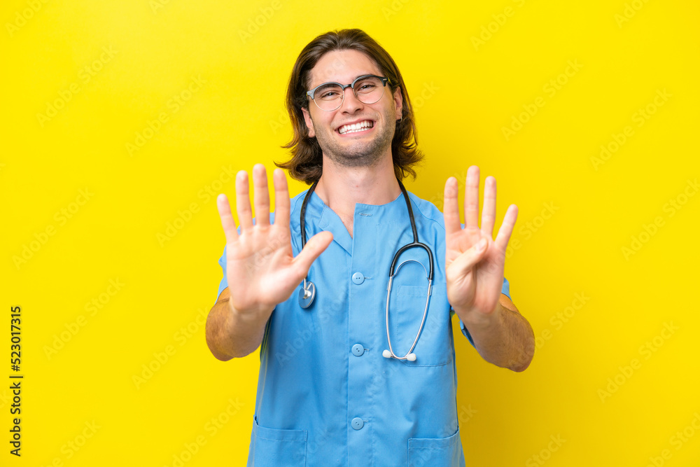 Young surgeon caucasian man isolated on yellow background counting nine with fingers Young surgeon caucasian man isolated on yellow background counting nine with fingers