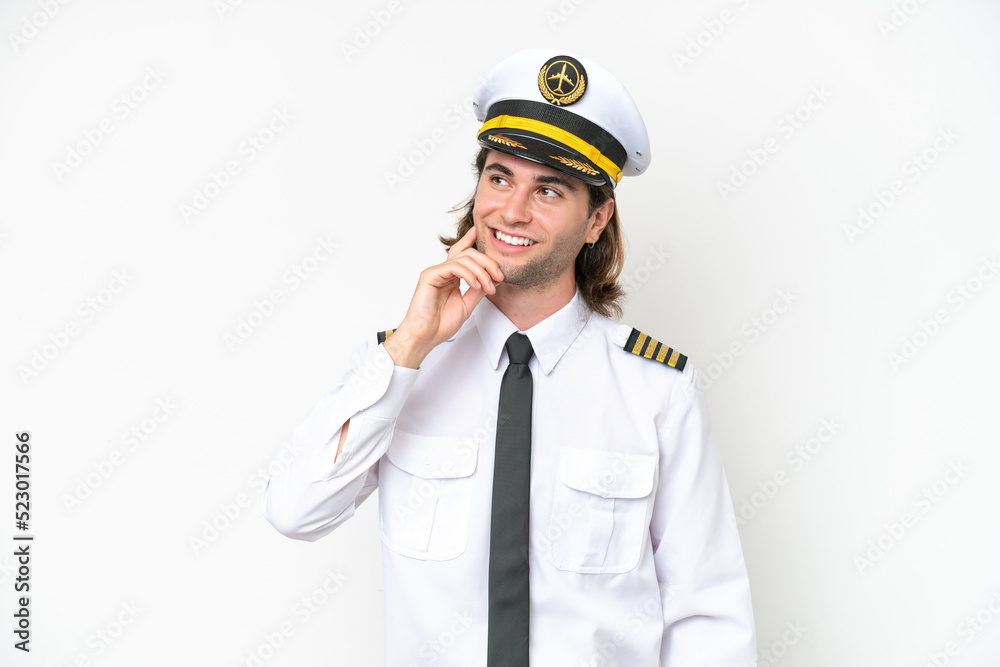 handsome Airplane pilot isolated on white background thinking an idea while looking up handsome Airplane pilot isolated on white background thinking an idea while looking up