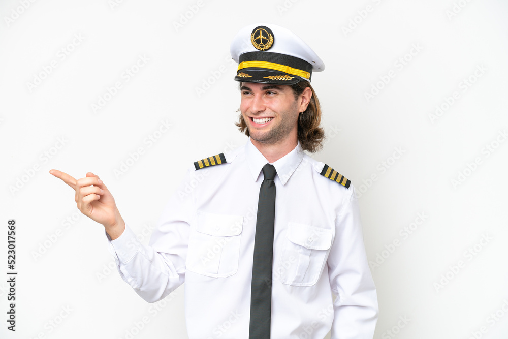 handsome Airplane pilot isolated on white background pointing finger to the side and presenting a product