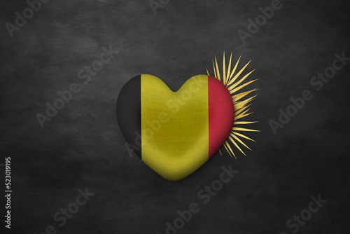 Textile heart in colors of national flag. Photography and marketing digital backdrop. Belgium © Julia
