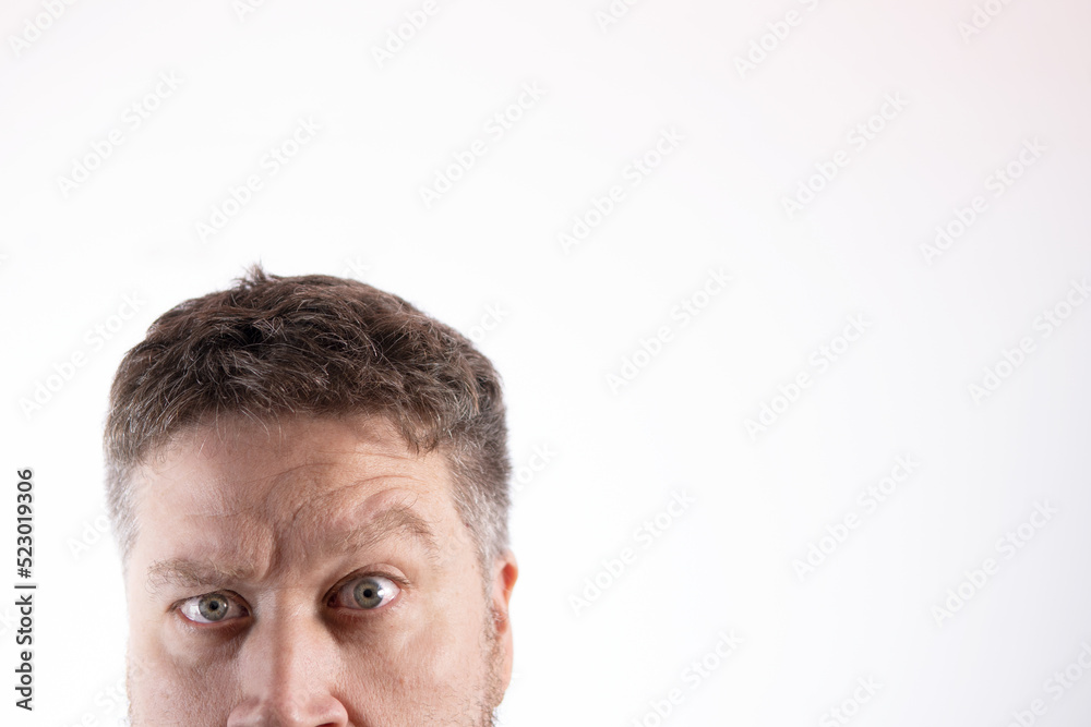 Fototapeta premium anonymous Caucasian face with blue eyes and a look of madness