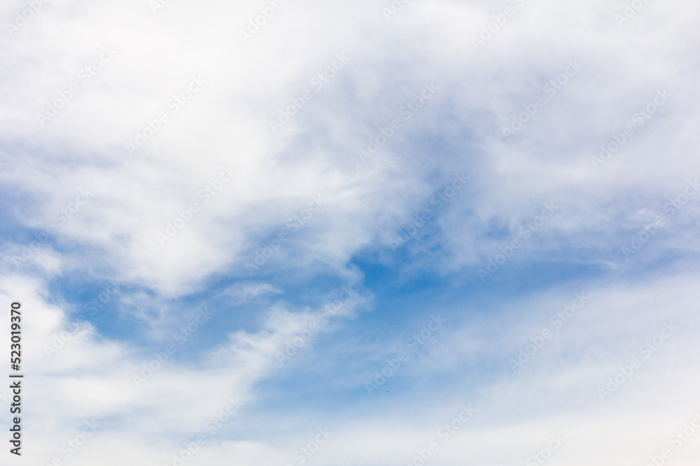 Clear blue sky with white cloud background