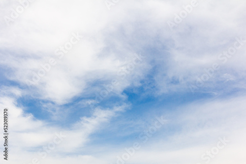 Clear blue sky with white cloud background