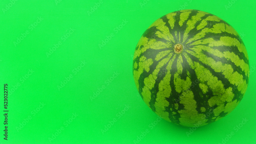 Watermelon on green background with copy space for text. Watermelon on green background with copy space for text.