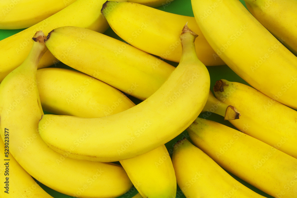 Many ripe yellow bananas as background