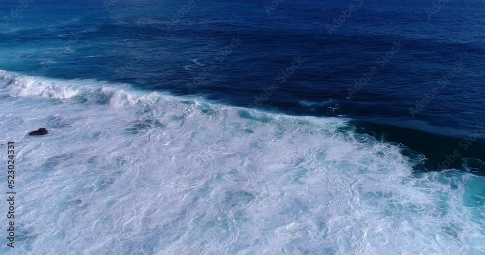 Aerial shot of the ocean with waves breaking over shallow coral reef Aerial shot of the ocean with waves breaking over shallow coral reef