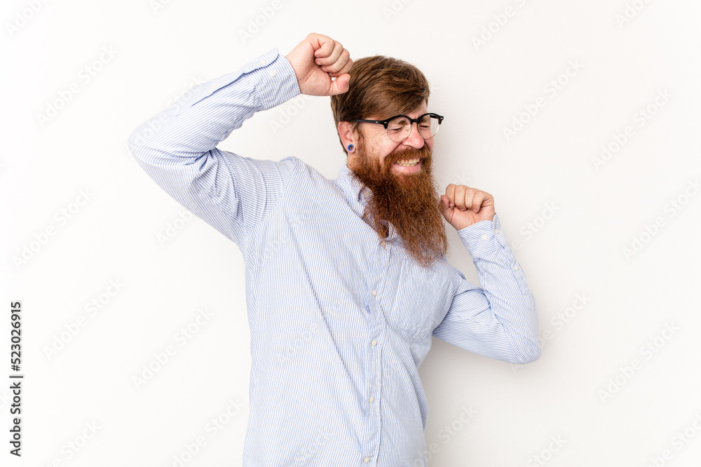 Young caucasian red-haired man isolated on white background celebrating a special day, jumps and raise arms with energy. Young caucasian red-haired man isolated on white background celebrating a special day, jumps and raise arms with energy.