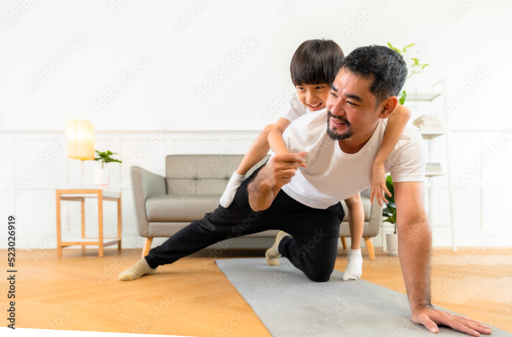 Young asian parents with child meditating at home isolated in room. Family, sport, yoga concept. Young asian parents with child meditating at home isolated in room. Family, sport, yoga concept.