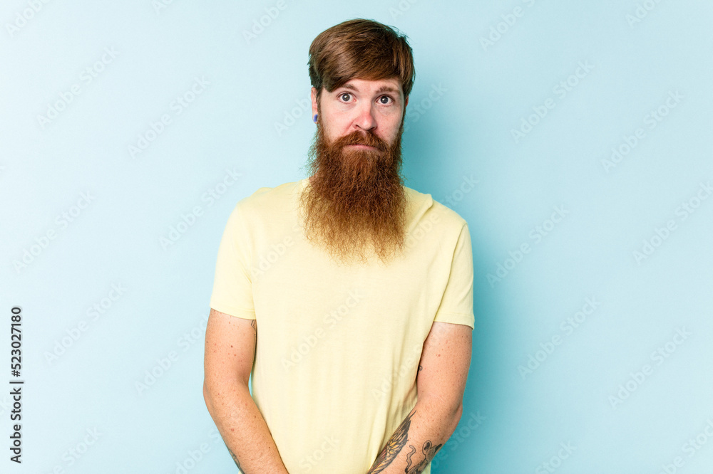 Young caucasian red-haired man isolated on blue background sad, serious face, feeling miserable and displeased. Young caucasian red-haired man isolated on blue background sad, serious face, feeling miserable and displeased.