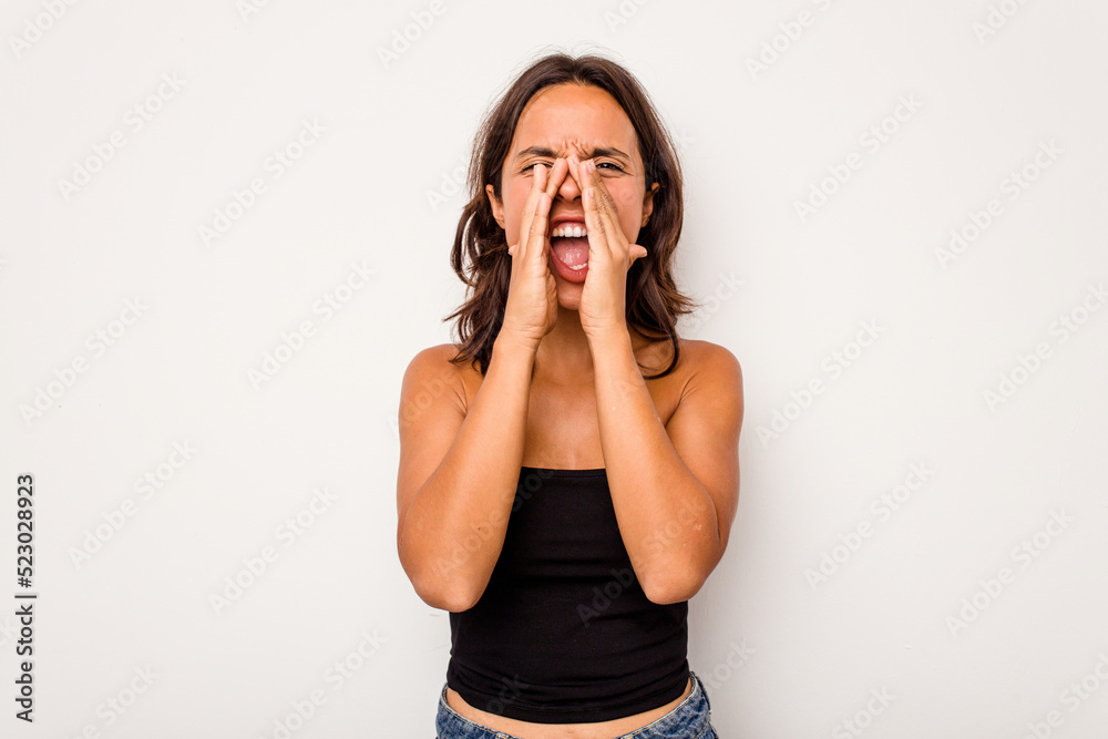 Young hispanic woman isolated on white background shouting excited to front. Young hispanic woman isolated on white background shouting excited to front.