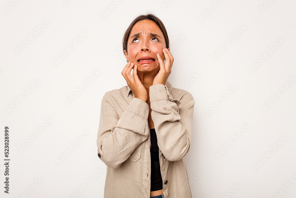 Young hispanic woman isolated on white background crying, unhappy with something, agony and confusion concept. Young hispanic woman isolated on white background crying, unhappy with something, agony and confusion concept.