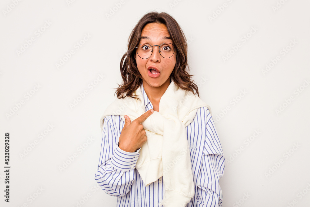 Young hispanic woman isolated on white background surprised pointing with finger, smiling broadly. Young hispanic woman isolated on white background surprised pointing with finger, smiling broadly.