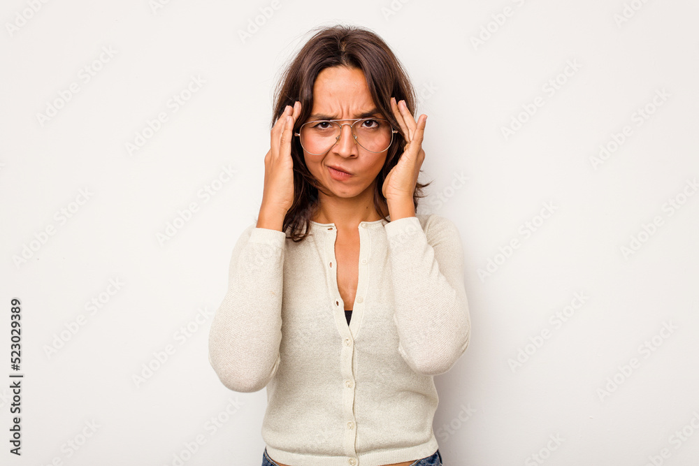 Young hispanic woman isolated on white background having a head ache, touching front of the face. Young hispanic woman isolated on white background having a head ache, touching front of the face.