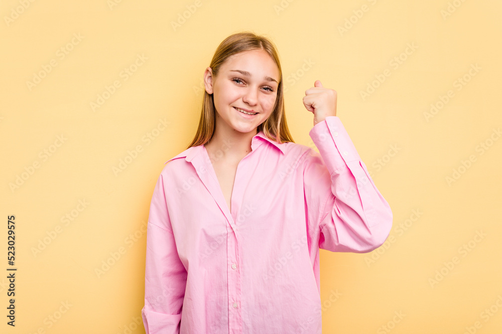 Young caucasian girl isolated on yellow background celebrating a victory, passion and enthusiasm, happy expression.