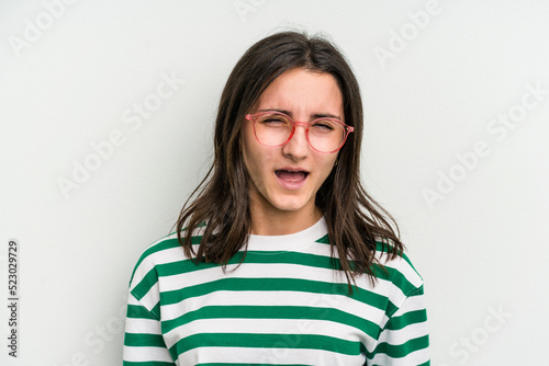 Young caucasian woman wearing a glasses isolated on blue background screaming very angry and aggressive. © Asier