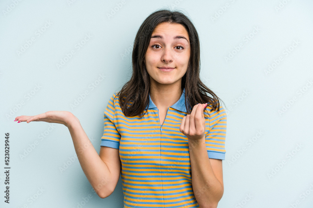 Young caucasian woman isolated on blue background showing that she has no money. Young caucasian woman isolated on blue background showing that she has no money.