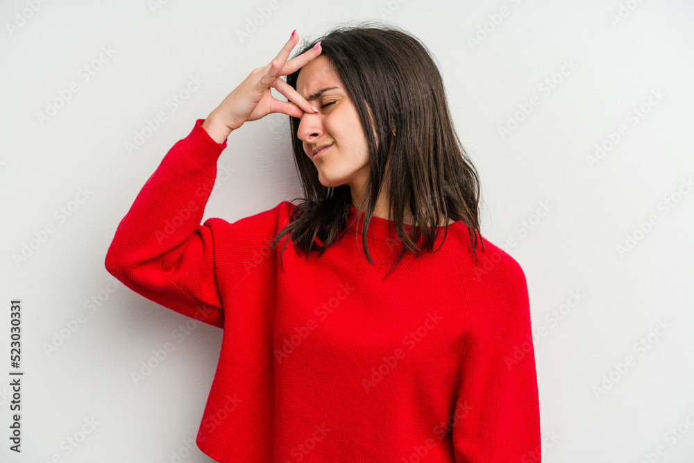 Young caucasian woman isolated on white background having a head ache, touching front of the face. Young caucasian woman isolated on white background having a head ache, touching front of the face.