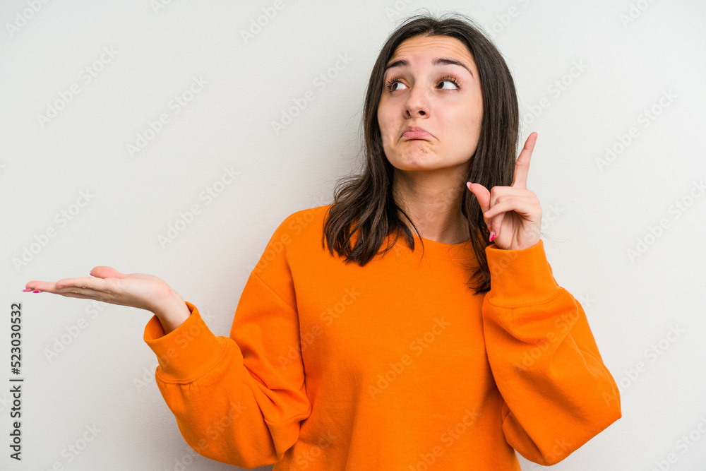 Young caucasian woman isolated on white background holding and showing a product on hand. Young caucasian woman isolated on white background holding and showing a product on hand.