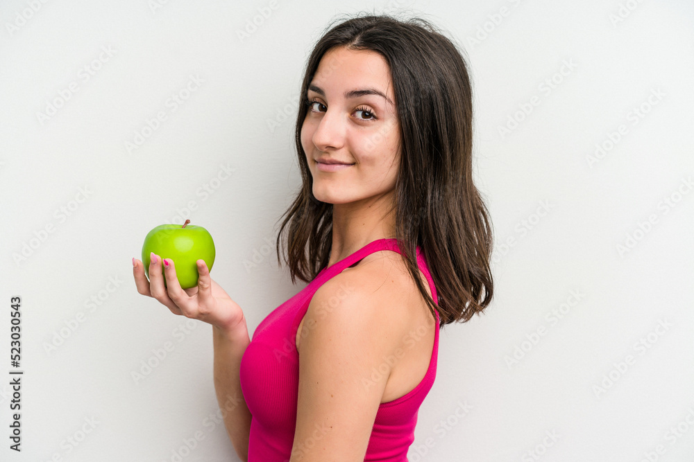 Young caucasian woman holding an apple isolated on white background Young caucasian woman holding an apple isolated on white background