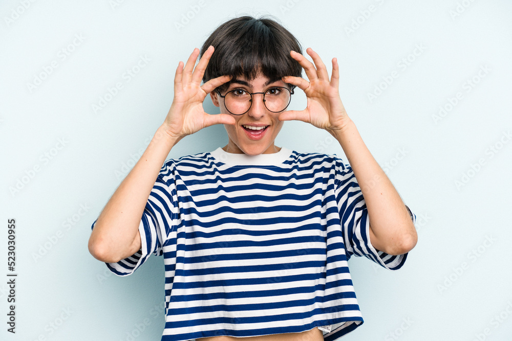 Young caucasian woman with a short hair cut isolated keeping eyes opened to find a success opportunity. Young caucasian woman with a short hair cut isolated keeping eyes opened to find a success opportunity.
