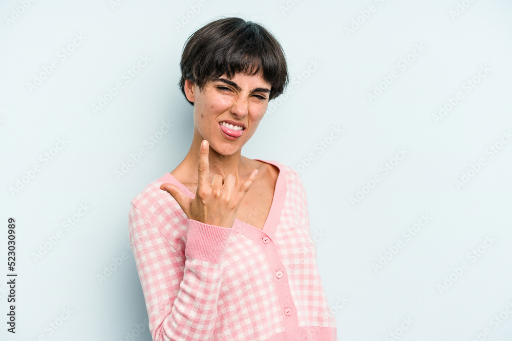 Young caucasian woman with a short hair cut isolated showing rock gesture with fingers Young caucasian woman with a short hair cut isolated showing rock gesture with fingers