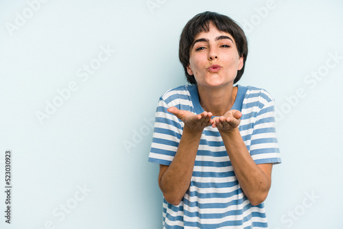 Young caucasian woman with a short hair cut isolated folding lips and holding palms to send air kiss.
