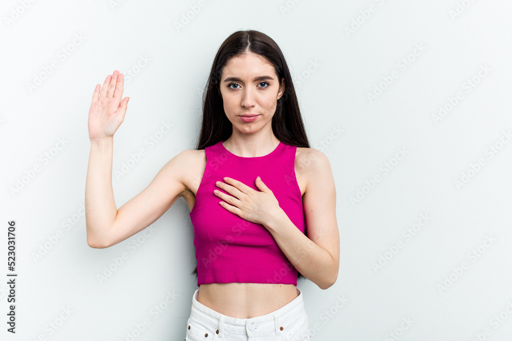 Young caucasian woman isolated on white background taking an oath, putting hand on chest. Young caucasian woman isolated on white background taking an oath, putting hand on chest.
