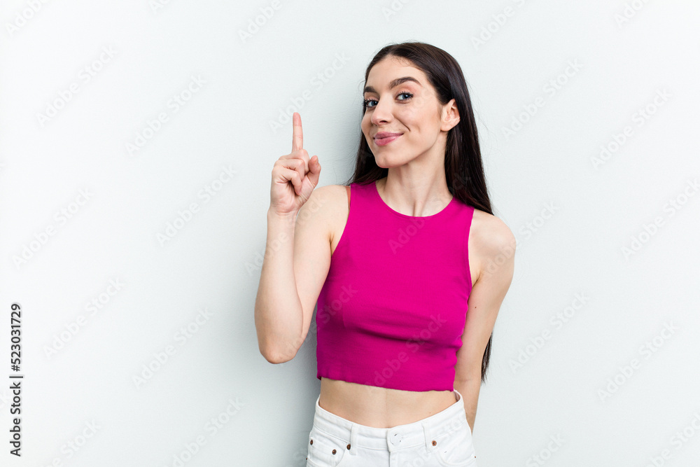 Young caucasian woman isolated on white background showing number one with finger. Young caucasian woman isolated on white background showing number one with finger.