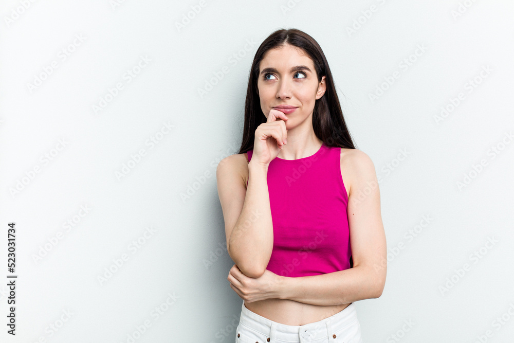Young caucasian woman isolated on white background relaxed thinking about something looking at a copy space. Young caucasian woman isolated on white background relaxed thinking about something looking at a copy space.