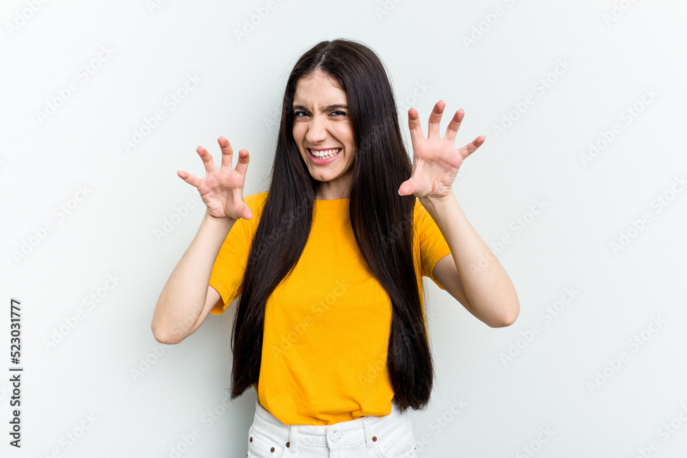 Young caucasian woman isolated on white background upset screaming with tense hands. Young caucasian woman isolated on white background upset screaming with tense hands.