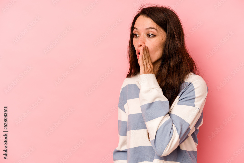 Young caucasian woman isolated on pink background being shocked because of something she has seen. Young caucasian woman isolated on pink background being shocked because of something she has seen.