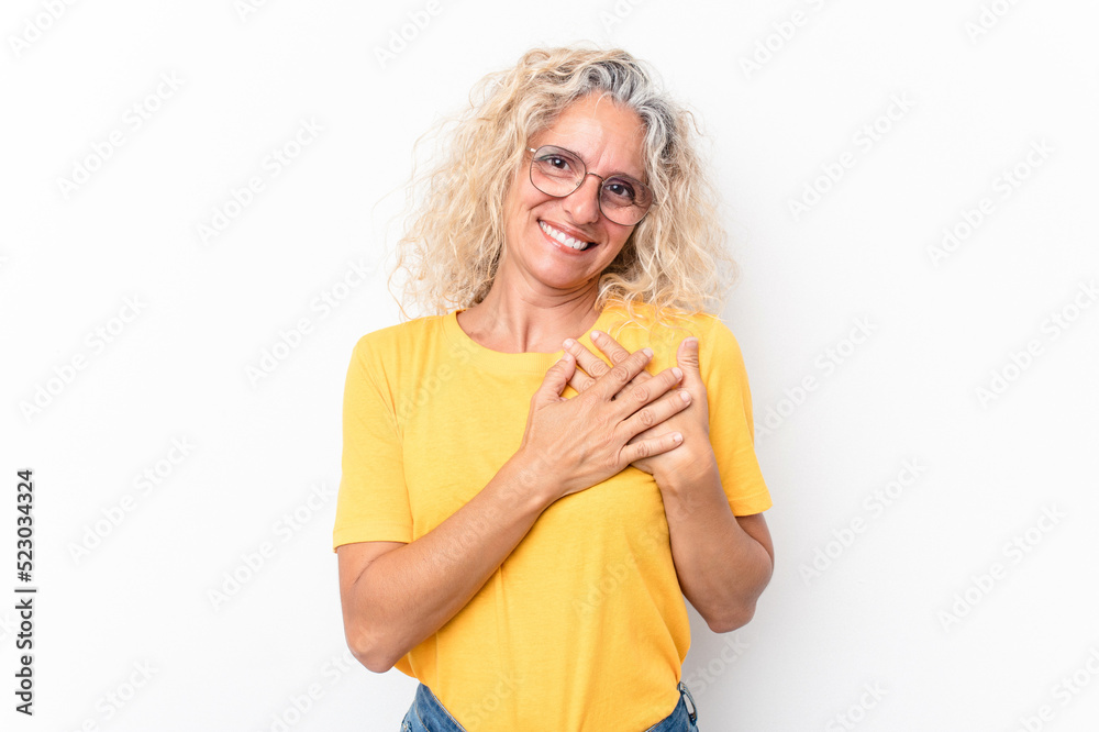 Middle age caucasian woman isolated on white background laughing keeping hands on heart, concept of happiness. Middle age caucasian woman isolated on white background laughing keeping hands on heart, concept of happiness.