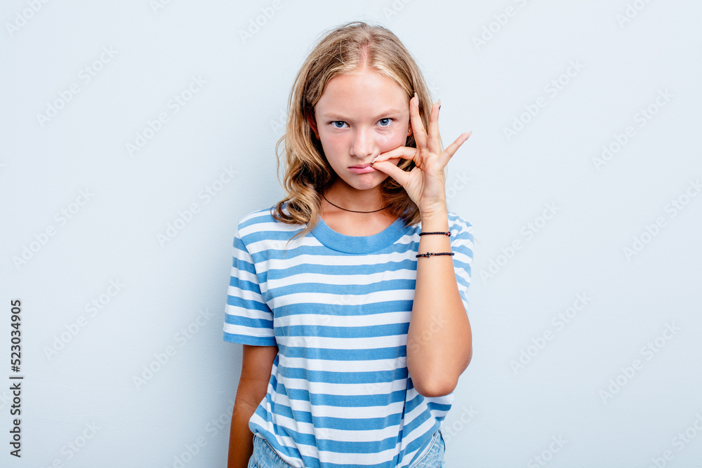 Caucasian teen girl isolated on blue background with fingers on lips keeping a secret. Caucasian teen girl isolated on blue background with fingers on lips keeping a secret.